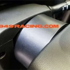 Car steering column with 949Racing sticker.