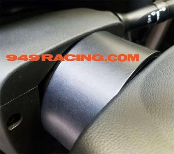 Car steering column with 949Racing sticker.