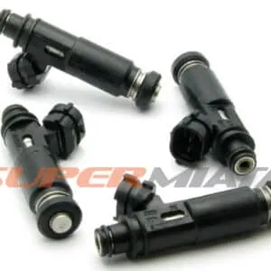 Four black fuel injectors for a vehicle.