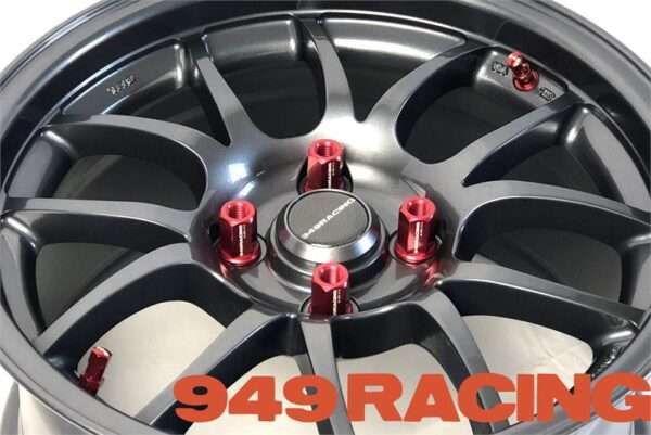 Black racing wheel with red lug nuts.