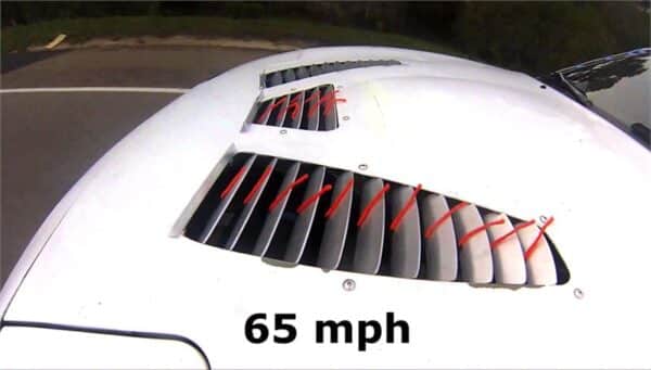 Car hood vent with speed indication at 65 mph.