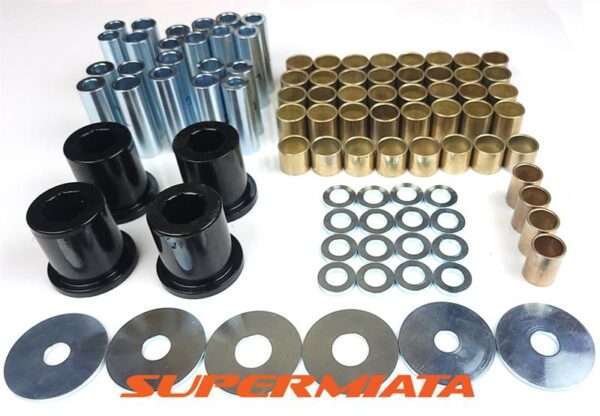 Assorted suspension bushing kit components on white background.