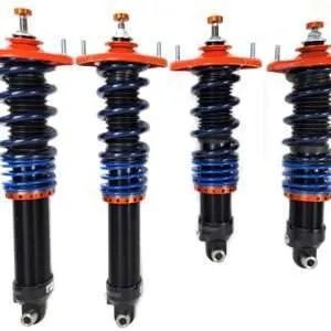 Four adjustable coilover car suspensions isolated on white.