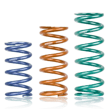 Multicolored metal coil springs on green background.