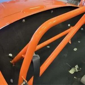 Orange roll cage in custom car interior.