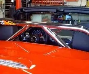 Orange race car with roll cage interior.