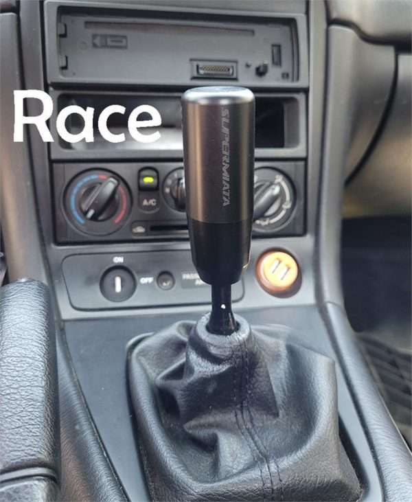 Car gear shift knob with "Race" text overlay.