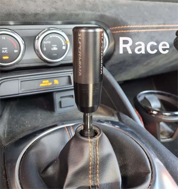 Car's manual gear shift with race mode button.