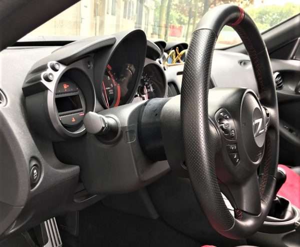 Car interior with steering wheel and dashboard.