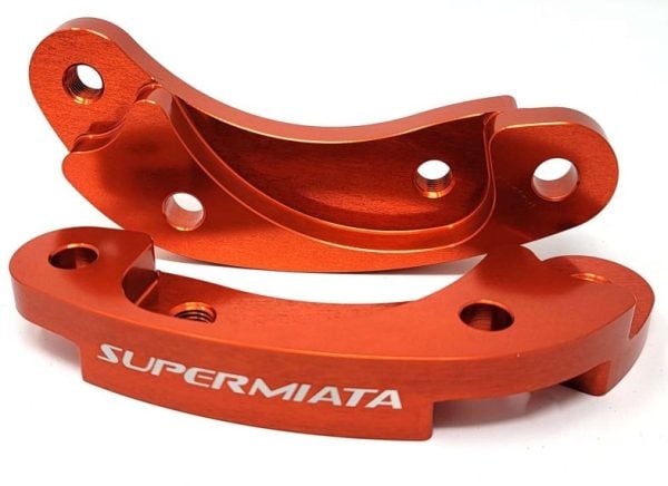 Red aftermarket SuperMiata car tow hooks.